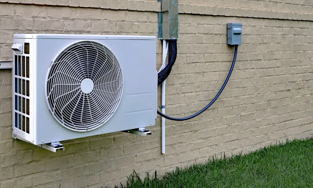 Cold-climate mini split heat pump running in a snowy winter setting